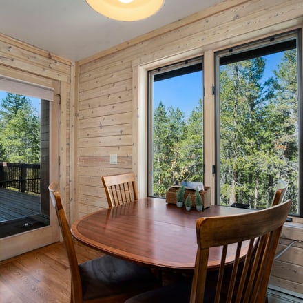 Mountain home kitchen with butcher block island and pine forest views